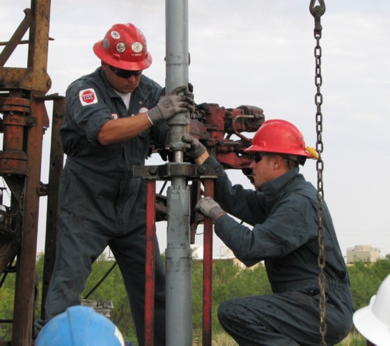 Workers drilling an oil well